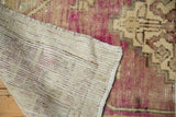 Distressed hand-knotted Oushak rug pile texture and woven reverse foundation with selvage.