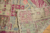 Vintage Oushak rug with distressed pink, blue pile, exposed foundation, and original side cord selvage.