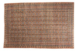 Vintage distressed Oushak carpet, allover floral pattern in terra cotta rust and blues.