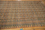 Distressed vintage Oushak rug edge with arrow-shaped, diamond borders, floral gul pattern.