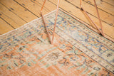 Distressed vintage Oushak rug with faded apricot, dusty blue floral vinery and even wear.