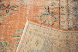 Distressed apricot Oushak pile texture revealing hand-knotted construction and even wear.