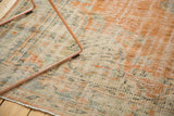 Distressed vintage Oushak rug texture with soft terra cotta, faded green, and foundation showing.