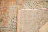 Vintage distressed Oushak carpet, detail of worn pile, visible foundation, and intact selvage.