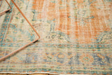 Distressed Oushak rug, even wear with exposed foundation, featuring faded terra cotta.