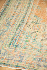 Distressed vintage Oushak pile with even wear showing terra cotta, faded blue, and green.