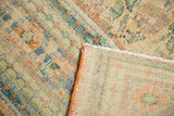 Distressed Oushak rug's pile showing even wear, visible foundation, and hand-knotted reverse.