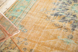 Distressed Oushak carpet's faded apricot field, light foundation, and subtle mint patterns.