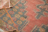 Pale cinnabar red field transitioning to dark geometric border and starburst motifs.