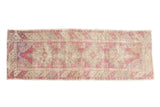 Vintage distressed Oushak rug runner with stepped geometric medallions in dusty purple, antique ivory, and slate blue.
