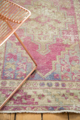 Textured low pile on a distressed Oushak rug with dusty purple stepped geometric motifs.