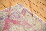 Oushak runner's barber pole border in dusty purple and ivory with original side cord selvage.
