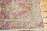 Geometric corner spandrel and barber pole border in time-softened dusty purple and ivory tones.
