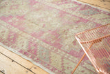 The time-softened palette of a distressed vintage Oushak runner in a natural setting.