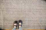 Distressed vintage Oushak carpet with subtle tone-on-tone floral design and mostly even wear.