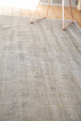 Textured pile of distressed vintage Oushak rug, showing even wear and muted ivory tones.