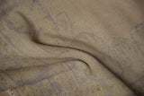 Distressed Oushak rug pile texture with even wear, muted beige and faint blue.