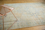 Distressed vintage Oushak carpet pile showing worn texture, faded royal blue on antique ivory.
