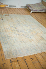 Distressed Oushak carpet texture, faded royal blue pattern, and antique ivory wear.