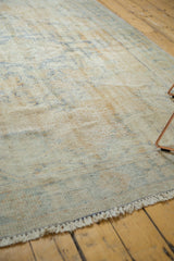 Short, textured fringe and worn pile revealing foundation details of a distressed Oushak rug.