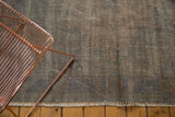 Distressed overdyed Oushak rug texture with visible foundation and soft fringed edge.