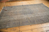 Turkish Vintage Distressed Overdyed Oushak carpet corner, showcasing worn texture and subtle blue-grey hues.