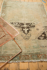 Distressed Oushak rug section showcasing geometric medallion, corner spandrel, and short pile.