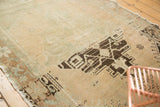 Distressed texture and contrasting charcoal geometric pattern on a vintage Oushak rug.