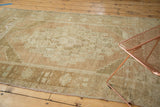Distressed pile texture with faded beige and sand tone-on-tone geometric patterns.