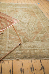 Distressed Oushak rug with even short pile, fringe, and intact selvage.