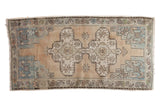 Vintage distressed Oushak rug, oblong medallion, and geometric sea foam blue spandrels.