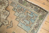 Vintage Oushak corner showing sharp stepped spandrels, floral cross-sections, and exposed knot heads.