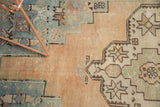 Low pile texture and abrasions on this vintage Oushak rug with geometric starbursts.