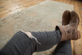 Vintage Distressed Oushak rug runner's faded ivory, peach, and mint geometric pattern with abrash.