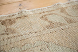 Textured pile of a distressed vintage Oushak runner, showing knot heads and abrash.
