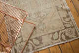 Faded floral and vine border of the distressed Oushak runner, showing abrash.