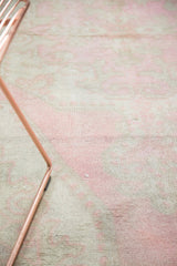 Distressed vintage Oushak rug with pale bubblegum pink, antique ivory pile and exposed knot heads.