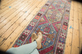 Hand-knotted Oushak runner close-up, featuring softened pink, purple, blue, ivory serrated medallions.