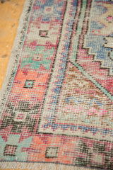 Distressed Oushak runner: short pile, pink and blue stepped geometric pattern, original selvage.