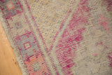 Distressed vintage Oushak rug texture with worn knot heads, sand ground, bright pink and plum purple pattern.