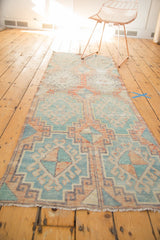 Distressed vintage Oushak runner detail, showing rectilinear hook-and-latch motifs in sea foam green and blush.