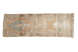 Distressed Vintage Oushak rug runner with faded blue, orange, and neutral diamond medallions, 3x9.