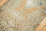 Decorative distressed texture and faded geometric patterns in sand, sky blue, and light brown.
