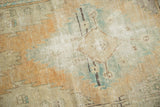 Distressed vintage Oushak runner's worn pile texture in beige, sand, and sky blue.