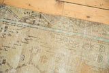 Distressed vintage Turkish Oushak runner with short pile, visible foundation, soft tones.