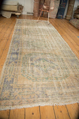 Distressed Oushak runner fringe with faded antique ivory, denim blue, celadon green tones.