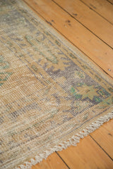 Textured distressed Oushak runner pile, with soft ivory, faded denim blue, celadon green, and fringe.
