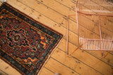 Bibikabad rug corner showing rust, tangerine, and blue floral vinery with tattered fringe.