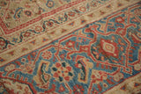 Persian Mahal carpet detail: classic herati motif field, vibrant sky blue and cherry red gem-tone border.