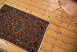 Vintage Engelas rug with brick red field, sky blue Herati motif, and fringed edge.